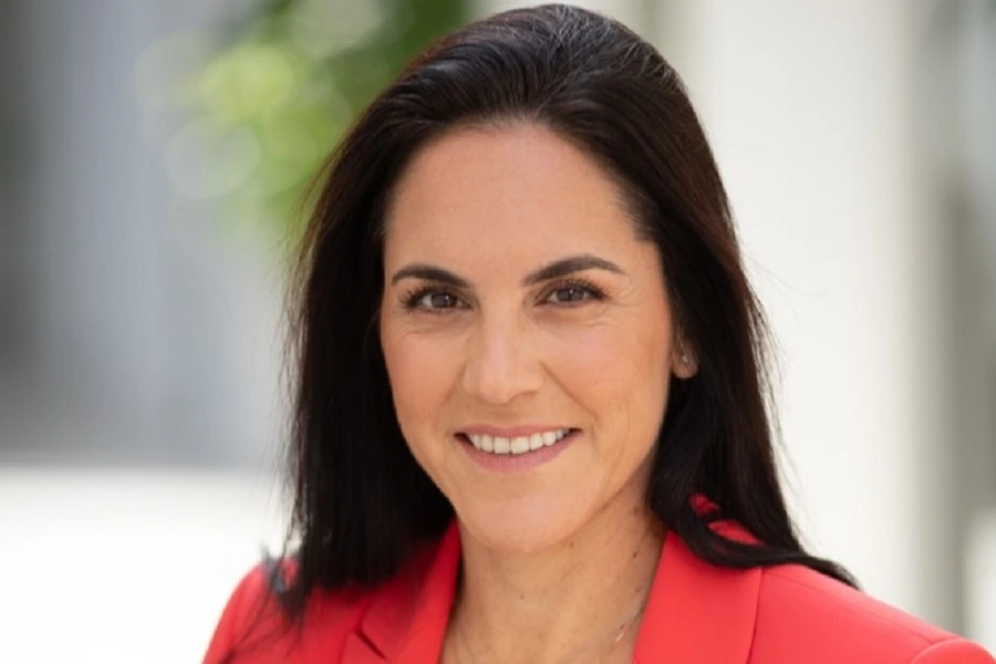 middle aged woman in red jacket smiling